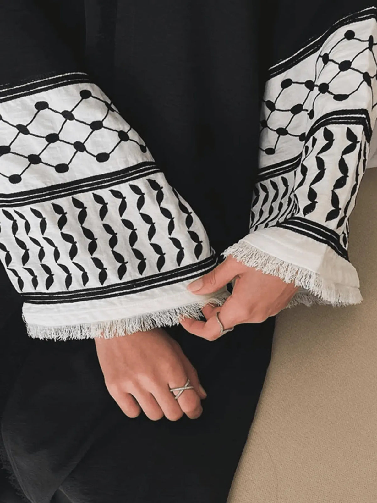 Embroidered cuff detail on a black open abaya