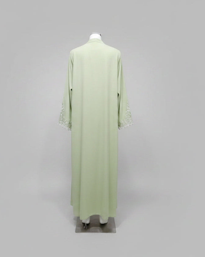 Back view of a green lace-trim open abaya