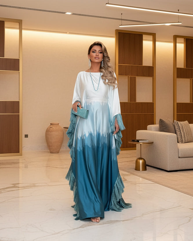 Woman wearing a blue ombre satin batwing modest maxi dress with fringe trim 1