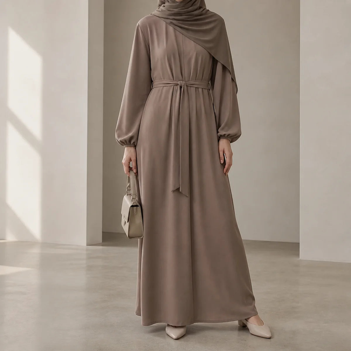 Taupe belted maxi dress styled with a matching hijab and structured handbag